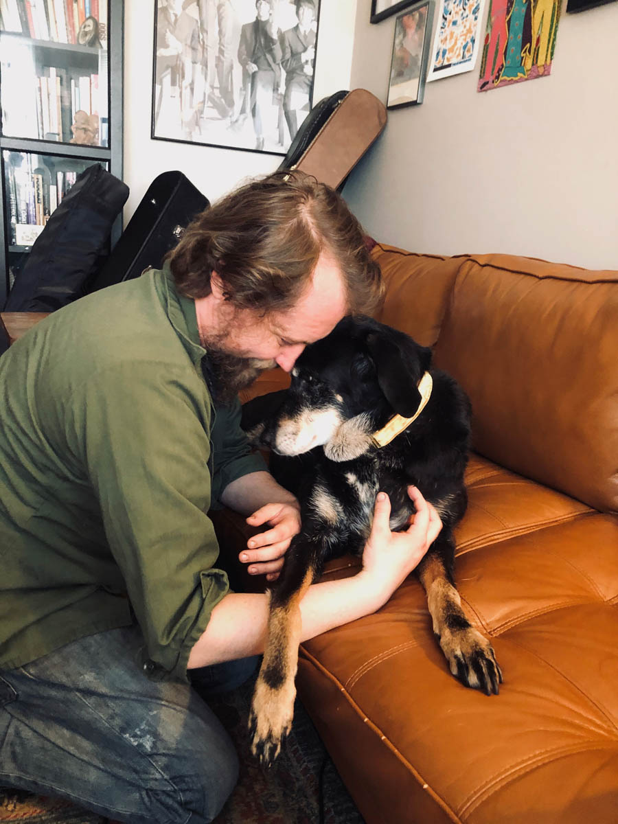 Bessie the big black dog forehead to forehead with her human